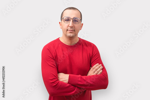 Portrait of a young man looking at the camera on a white background. © Andrii