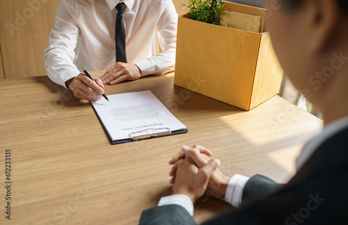 Quit Job Business man sending resignation letter and packing Stuff Resign Depress or carrying business cardboard box in office. Change of job or fired from company.