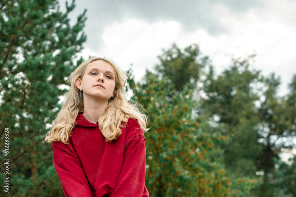 Blond girl day dreaming at park Blond girl day dreaming at park