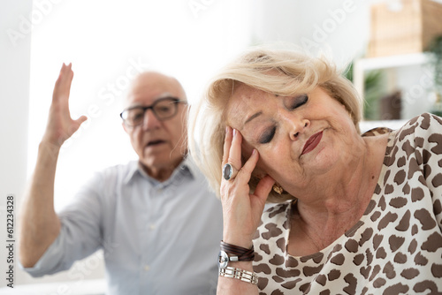 Despaired senior woman ignoring husband