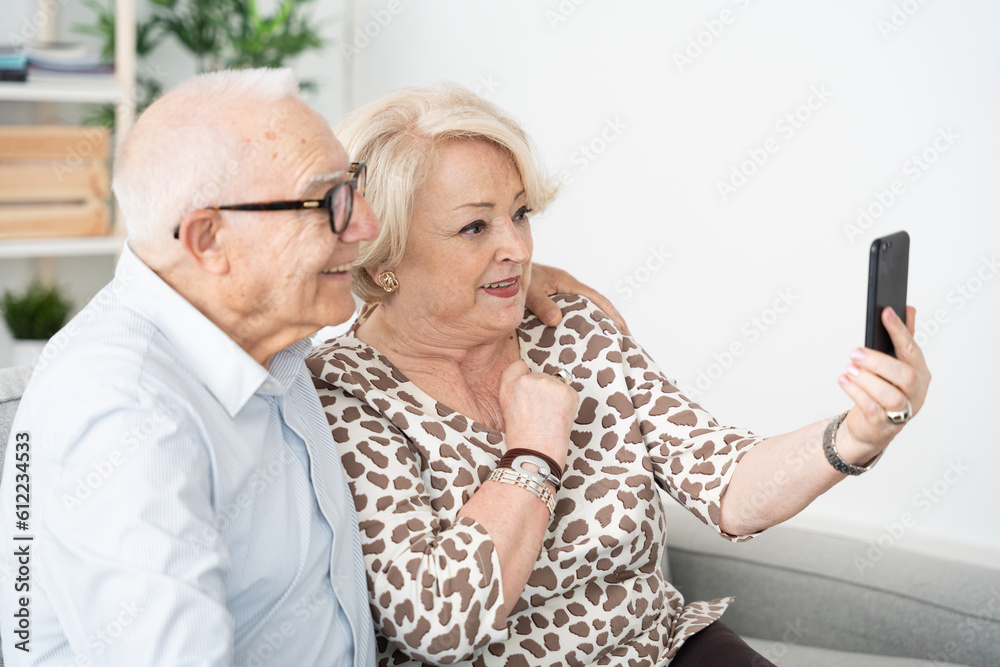 Elderly man and woman using phone Elderly man and woman using phone