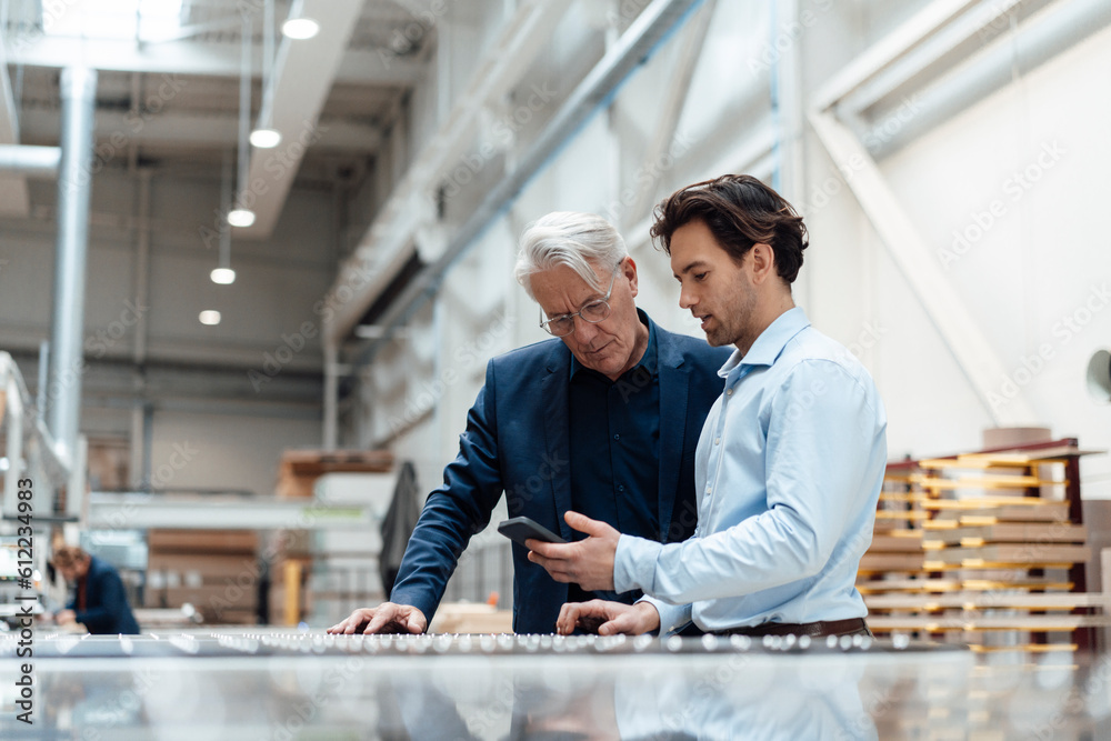 custom made wallpaper toronto digitalYoung businessman discussing over smart phone with colleague at industry