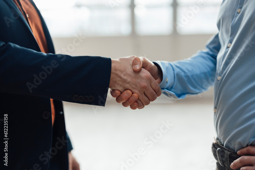 Businessman shaking hands with colleagues at industry