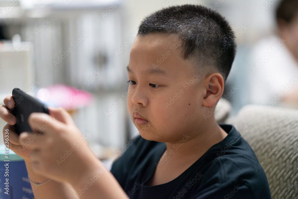 Children play games on mobile phones in the house. Children play games on mobile phones in the house.