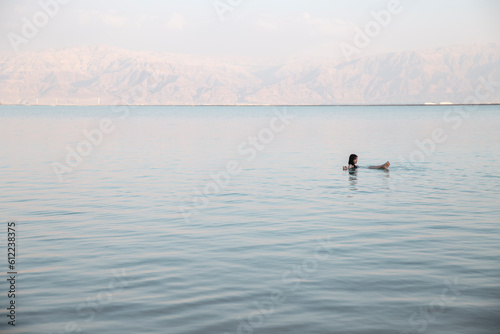 Young woman swimming in dead sea, Israel