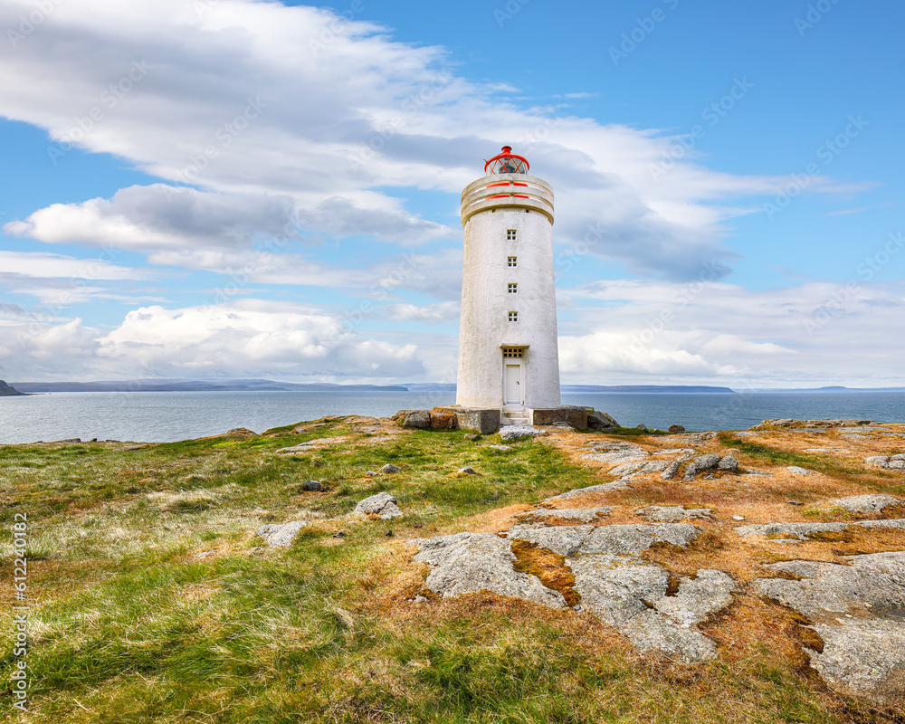Breathtaking view of Skarsviti lighthouse in Vatnsnes peninsula on a clear day in North Iceland.