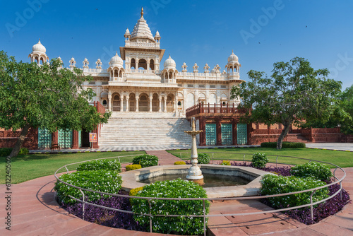 Nice view of Jaswant Thada cenotaph with decorated garden fountain, Jodhpur, Rajasthan, India. Built out of intricately carved sheets of Makrana marble, emitting warm glow when illuminated by Sun.