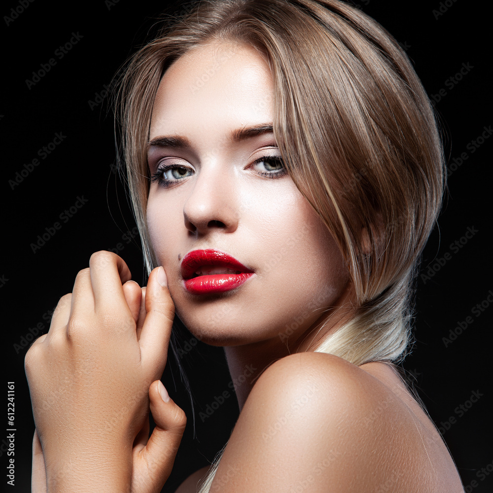 Portrait of young woman with beautiful professional makeup on dark background