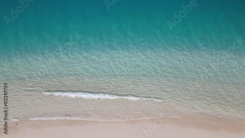 Top-down aerial drone view of paradise sandy beach and crystal clear water photo