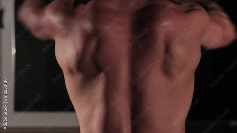 Pumping the back muscles on the trainer at the gym. The athlete is exercising Pumping the back muscles on the trainer at the gym. The athlete is exercising