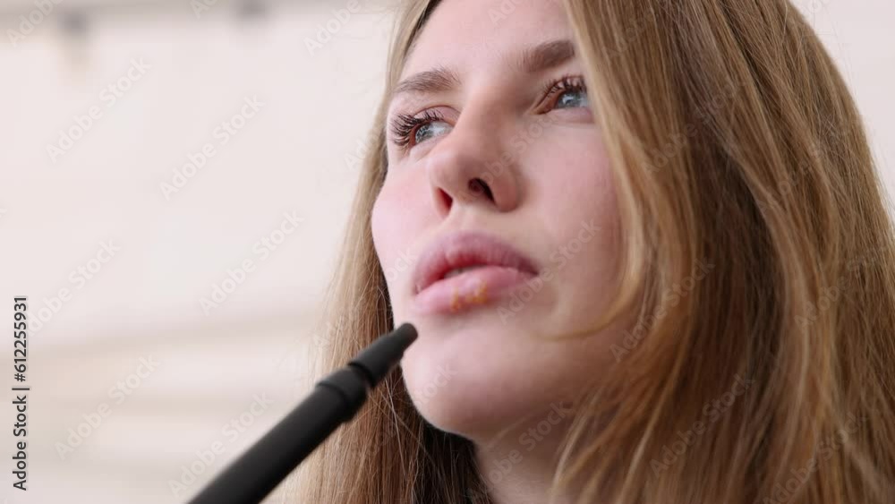 girl woman smoking hookah in terrace restaurant sitting with coffee cup on table,typing message on phone.female with cold sore herpes hpv virus on lips 4k.hookan man putting coal cubes on tabaco bowl