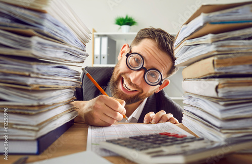 фотографія Funny bookkeeper has much paperwork