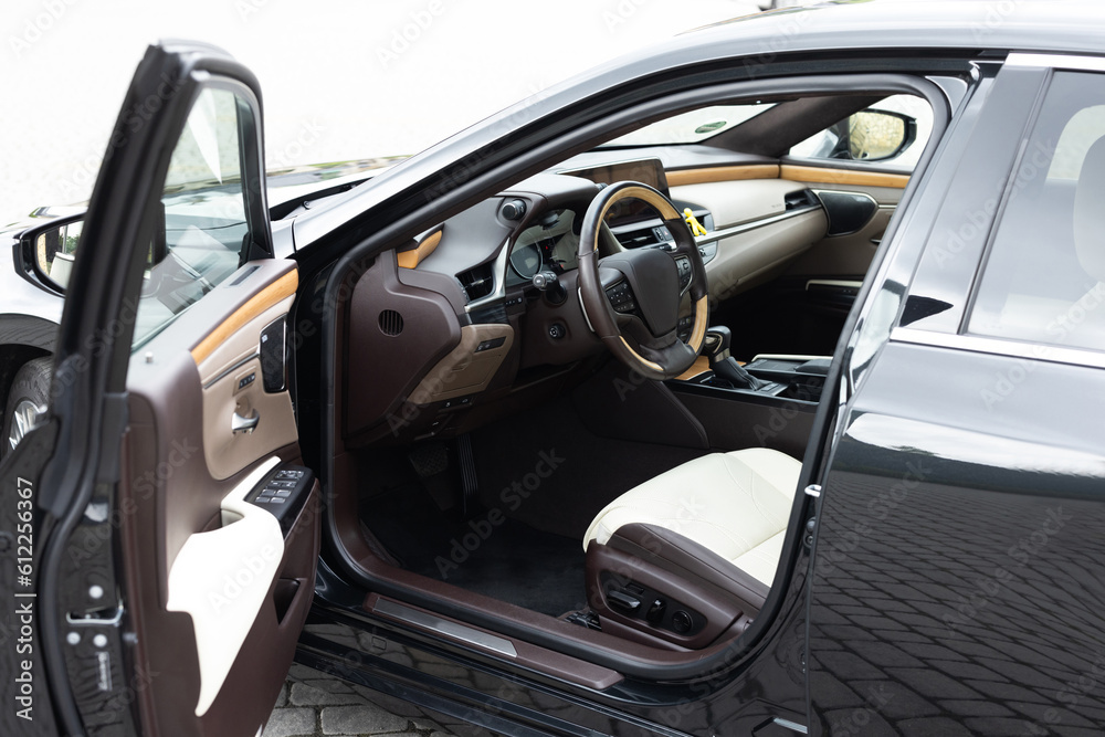 Modern luxury car Interior - steering wheel, shift lever and dashboard. Car interior luxury inside. Steering wheel, dashboard, speedometer, display. Brown leather interior. White leather interior