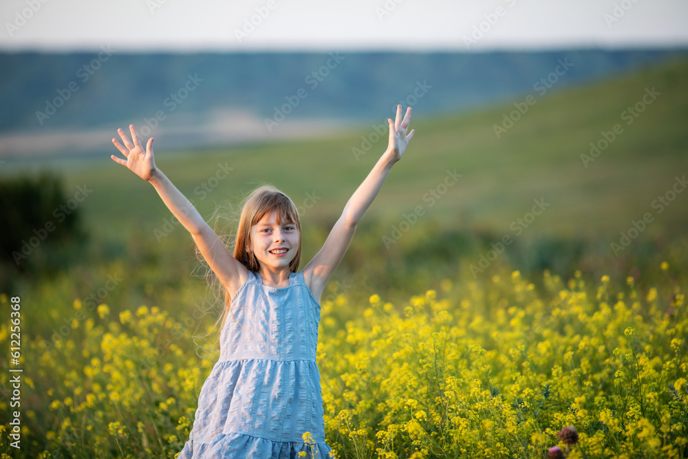 freedom and happiness concept. Happy little girl with hands raised high up in nature freedom and happiness concept. Happy little girl with hands raised high up in nature
