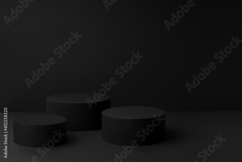 Abstract black scene with three cylinder podiums template for presentation cosmetic products, goods, advertising, design, sale, card, poster, text, flyer in soft gradient, mockup in minimalism style.