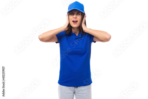 pretty surprised young woman in blue cotton t-shirt and cap with mockup isolated on white background with copy space
