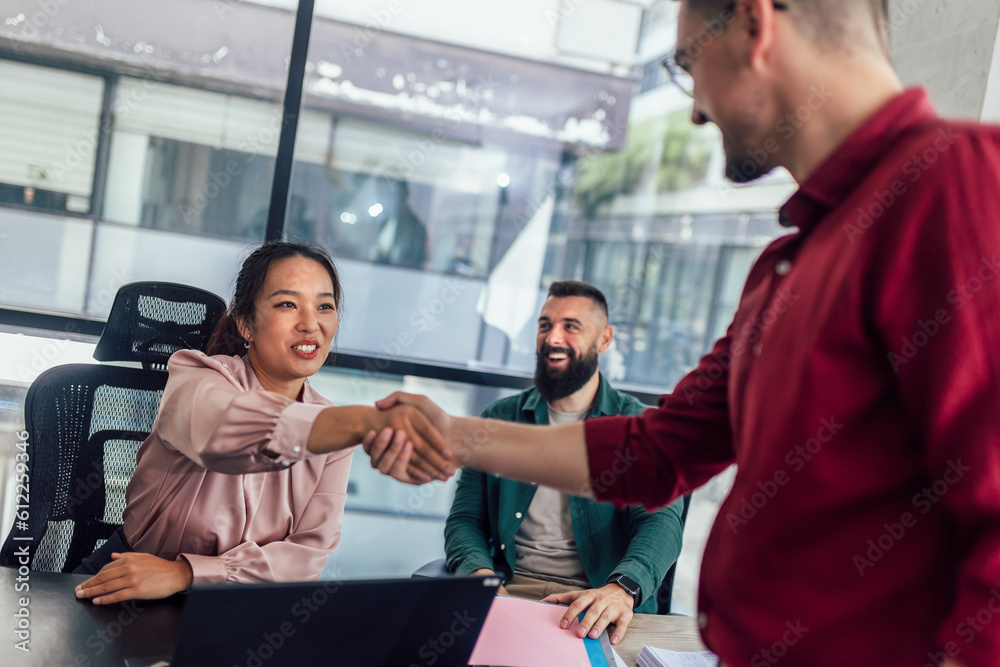 Human resource team talking to a candidate during a job interview in the office. Human resource team talking to a candidate during a job interview in the office.