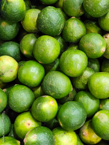 Close up view of pile of Citrus Aurantiifolia at market. Ripe and juicy.
