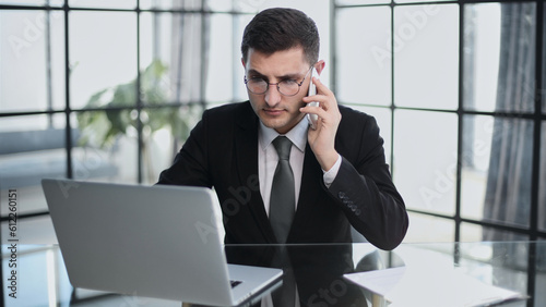 Portrait of a young serious businessman in a casual office