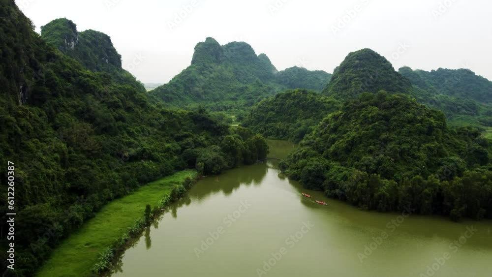 Drone Ascending Over Ninh Binh Bird Park with Karst Mountains Backdrop in Vietnam Drone Ascending Over Ninh Binh Bird Park with Karst Mountains Backdrop in Vietnam