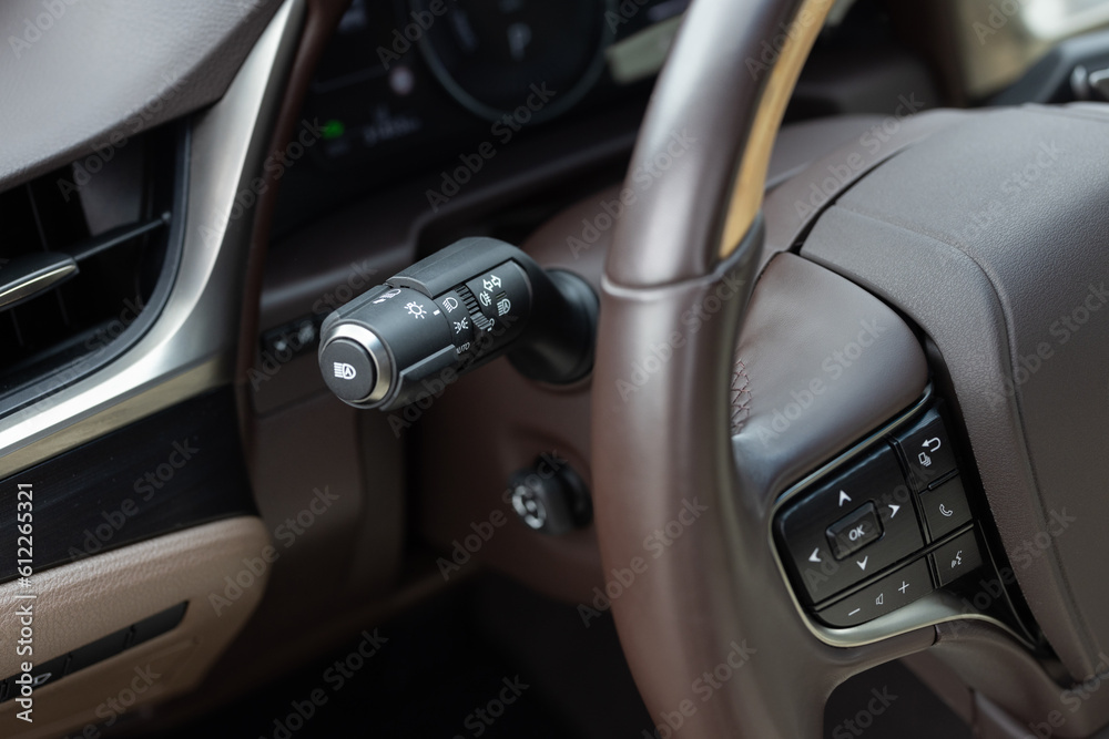 Multifunction Headlight Console Control Switch knob. The light knob in the car. Fog light switch. Car front headlight headlamp control stick on the left side of steering wheel. Car with light switch