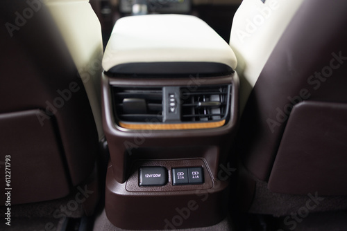 Air-condition panel in interior of a new car. Two USB C ports for the rear seats in a passenger car. Modern car usb socket for charging and accessories. 12v power socket inside car interior. © uflypro