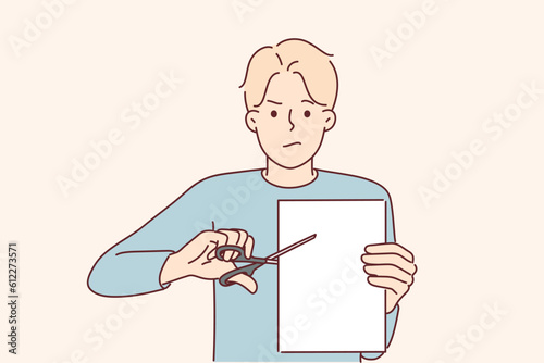 Man with scissors cuts sheet paper for concept of breaking contract and destroying document
