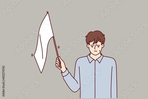 Man with white flag gives up, admitting own defeat due to lack of strength and motivation to fight and achieve goals. White flag guy stands put head down after bankruptcy or dismissal