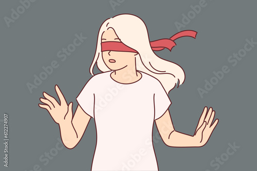 Blindfolded girl cannot navigate in space due to forced blindness and turns with frightened emotions