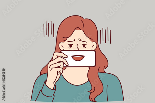 Depressed woman with fake smile hides emotions pretending to be extrovert and happy human. Depressed girl with talking mouth on phone screen symbolizes psychological problems and lack of own opinion.