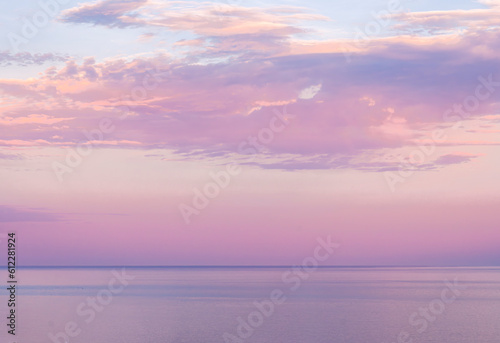 scenic blue seascape of sunset or sunrise above water with beautiful colorful evening clouds, deep blue rain clouds, natural weather concept © Yaroslav