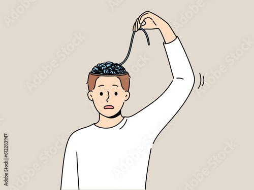 Man with mental problems associated with confusion needs help of psychologist to improve mental health. Young guy is confused trying to unravel threads in brain and looks into camera