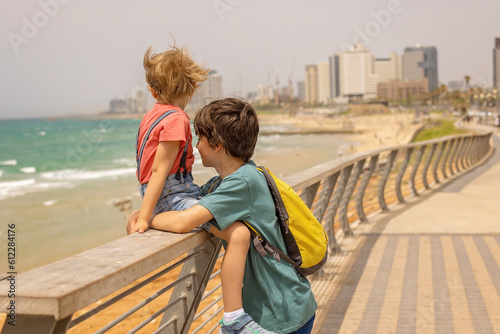 European tourist family with children, visiting Tel Aviv, Israel, enjoying day walk