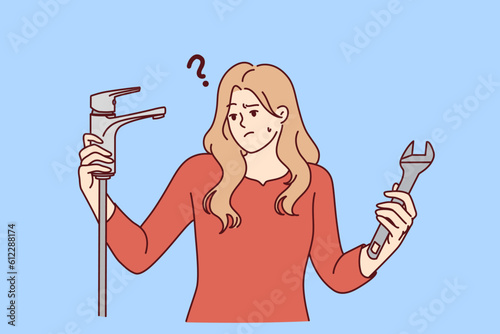 Woman with water faucet and wrench does not understand how to fix water supply or get rid of leak. Girl repairs faucet in bathroom or in kitchen with own hands, not wanting to call plumber