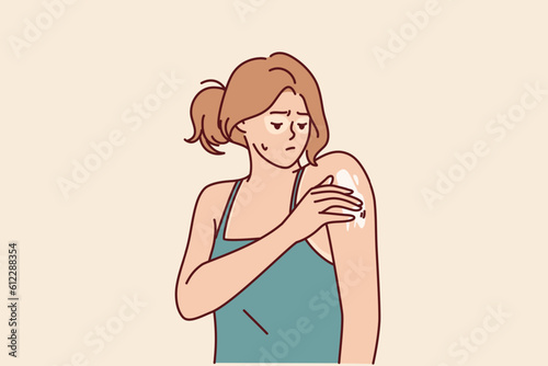 Woman with sunburned applies healing cream on shoulder to repair skin after exposure to ultraviolet. Sad girl who has sunburned face and hands suffers from itching or flaky skin causing pain