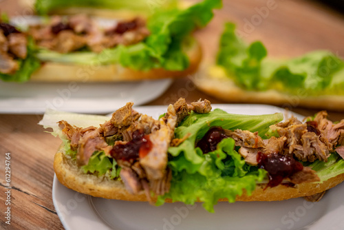 Delicious healthy sandwich, snack, meat and cranberry, lettuce, healthy with vegetables, green background, appetizing meal snack.