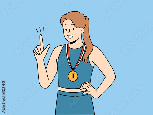 Woman athlete with sports medal for second place in running or gymnastics competition points up and smile. Champion girl recommends purchasing quality sportswear to achieve success in sports career