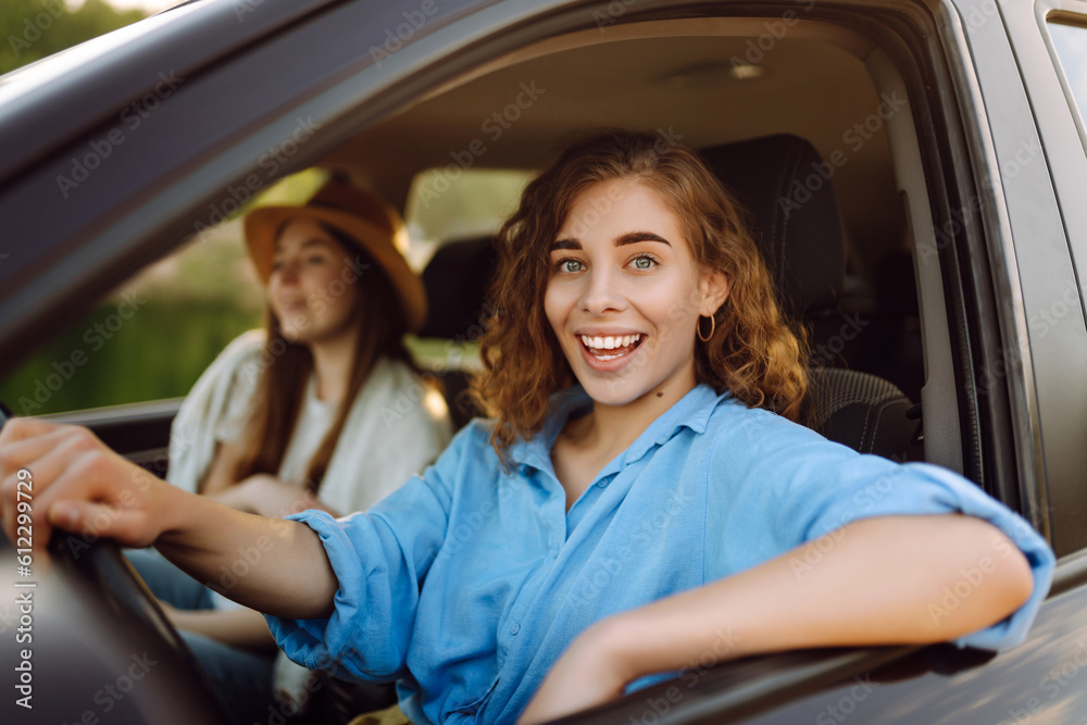 Two young women on car trip having fun. Lifestyle, travel, tourism, nature, active life.