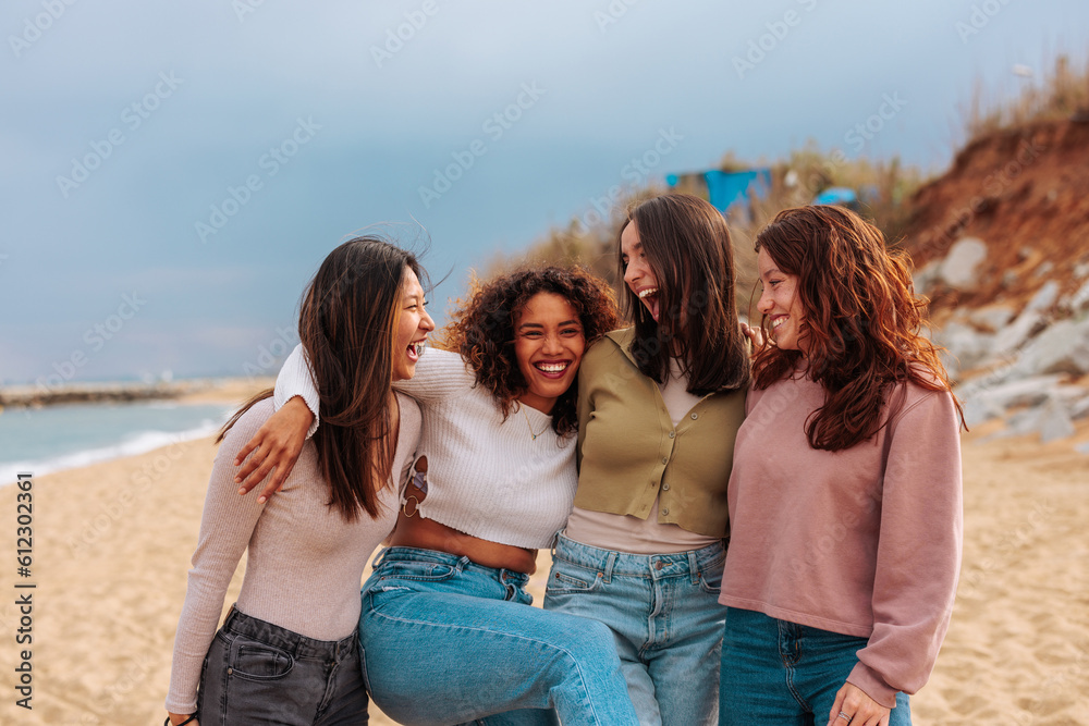 Four diverse young girls standing together at beach. Four diverse young girls standing together at beach.