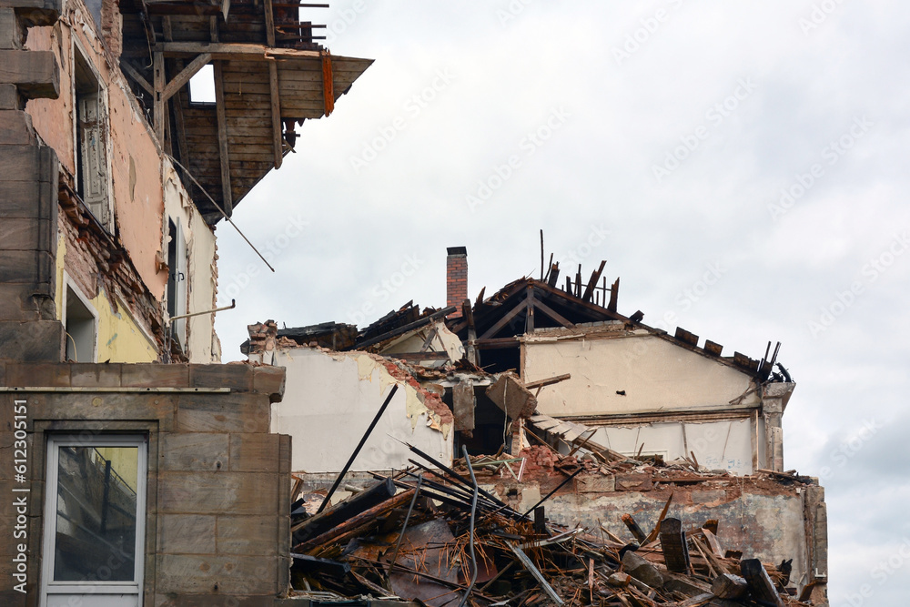 Houses destroyed as a result of military shelling against the background of the sky. View from below Houses destroyed as a result of military shelling against the background of the sky. View from below