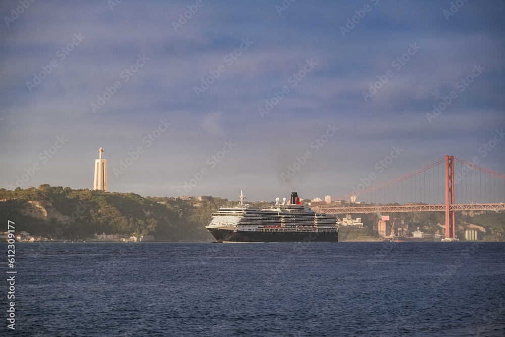 Luxury ocean liner cruiseship cruise ship Victoria or Elizabeth in port of Lisbon, Portugal during Mediterranean cruising with city skyline, Christos statue and suspension bridge Luxury ocean liner cruiseship cruise ship Victoria or Elizabeth in port of Lisbon, Portugal during Mediterranean cruising with city skyline, Christos statue and suspension bridge