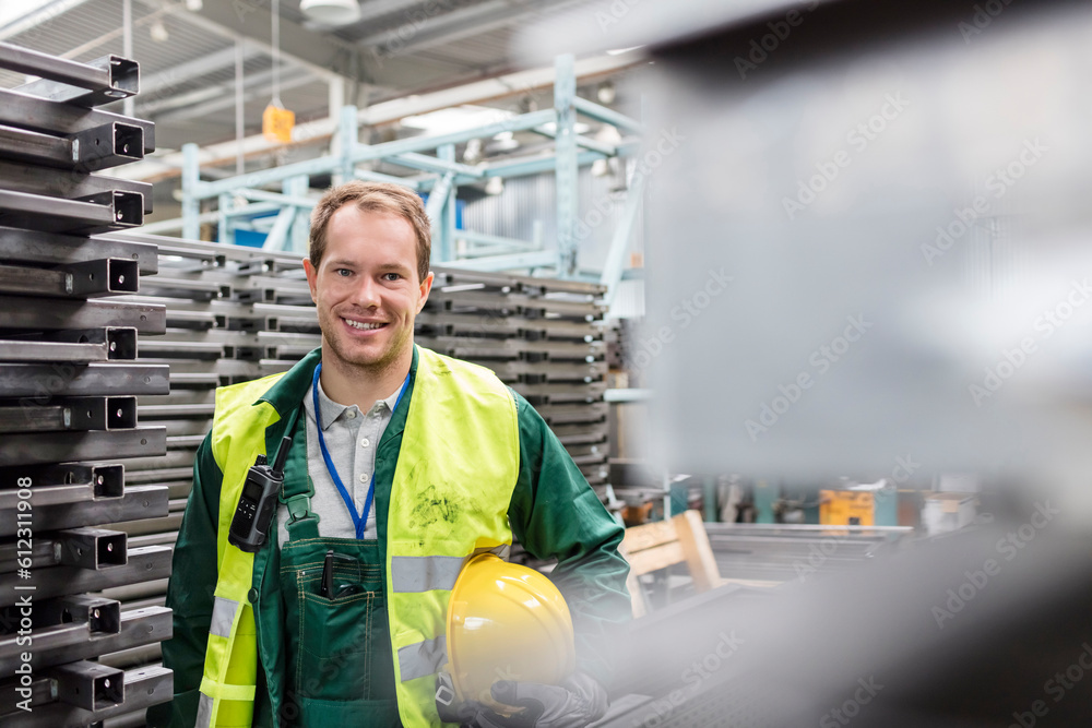 Portrait smiling worker in protective workwear in steel factory Portrait smiling worker in protective workwear in steel factory