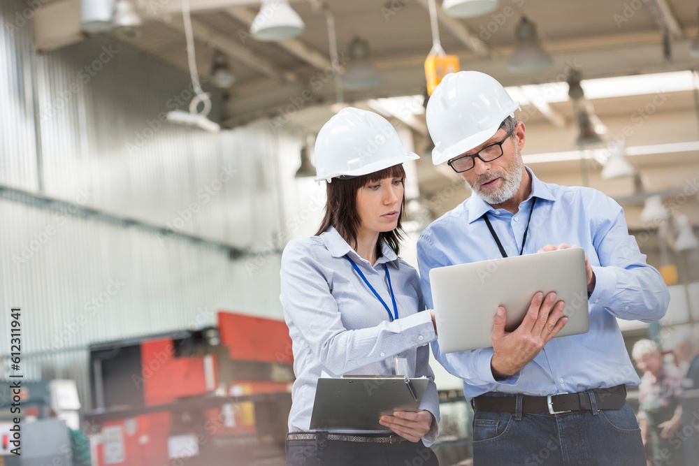 Engineers with laptop in factory Engineers with laptop in factory