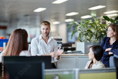 Tableau sur toile Businessman leading meeting in office cubicle