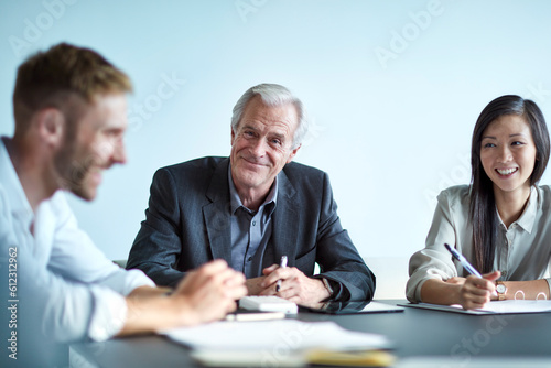 Portrait smiling senior businessman in meeting