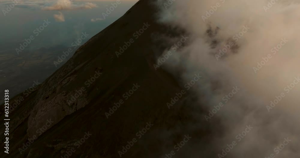 Fuego volcano during sunset in Guatemala. Aerial tilt-up