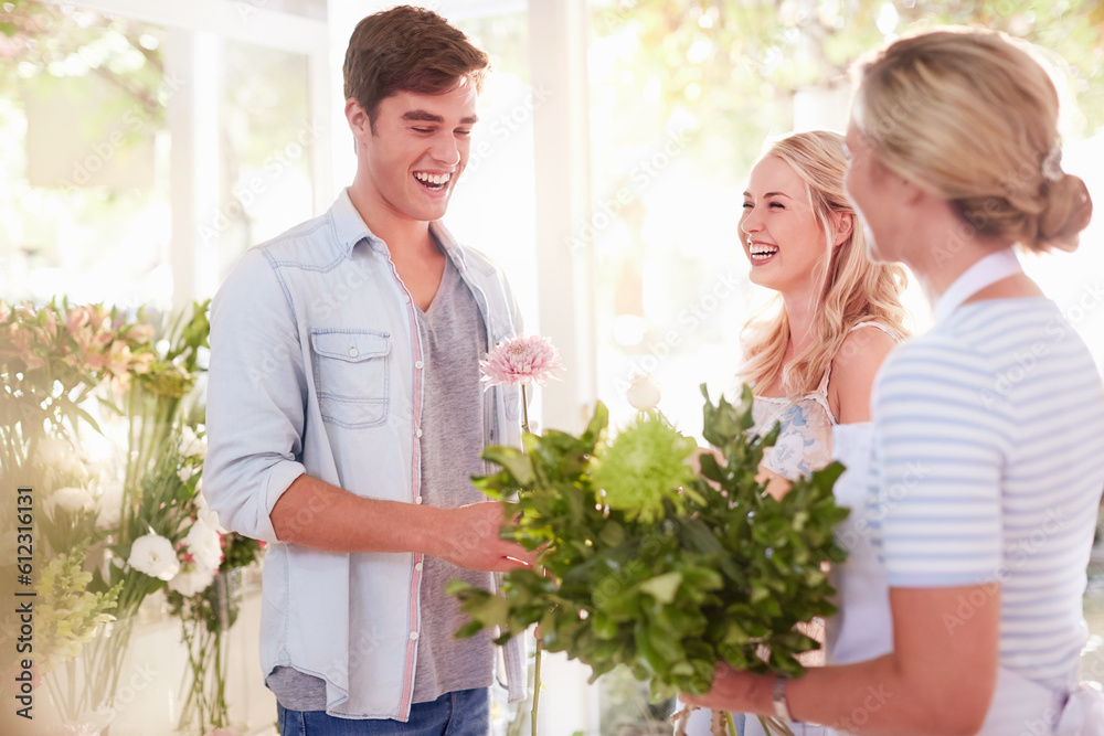 Florist preparing bouquet for couple in flower shop Florist preparing bouquet for couple in flower shop