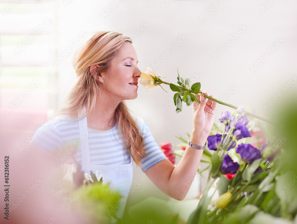 Florist smelling rose in flower shop Florist smelling rose in flower shop