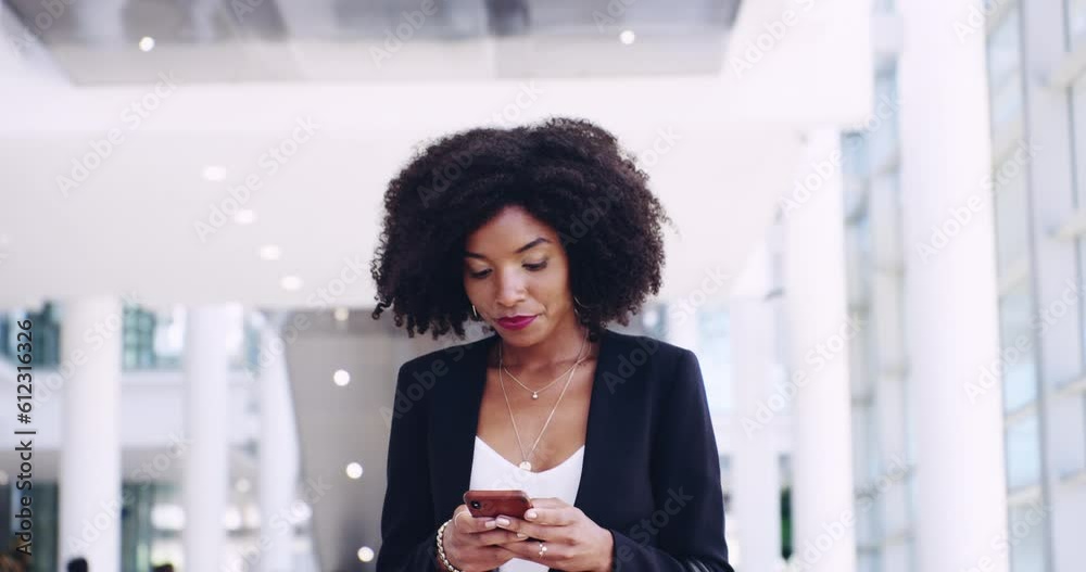 Phone, communication and a business woman walking in the office for professional work. Portrait, thinking and smile with a happy young black female employee typing a text message in the workplace