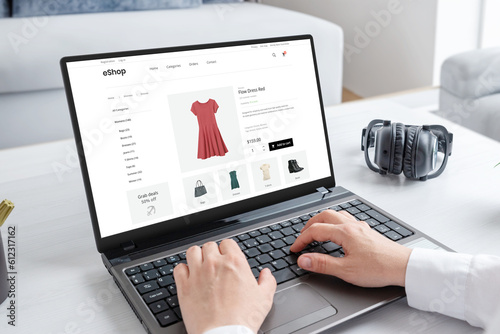 Woman purchasing a stunning red dress online with laptop computer. Modern ecommerce web page interface